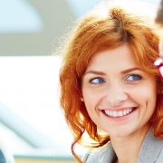 Pretty young employee looking at her colleague during discussion of data